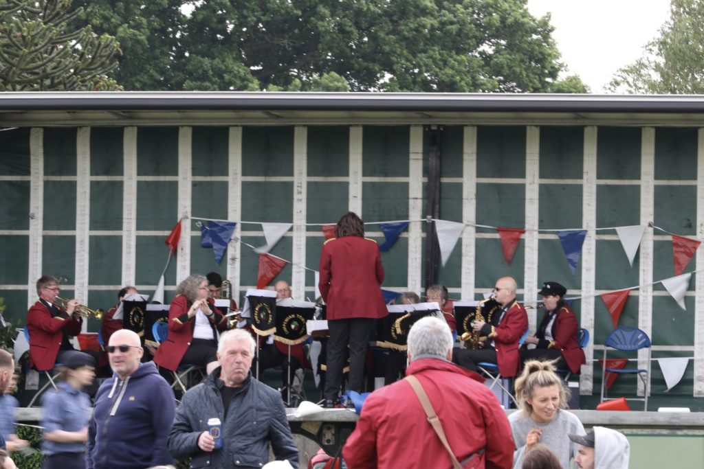 Chippenham Town Band playing on the stage at Rowde's Jubilee Picnic