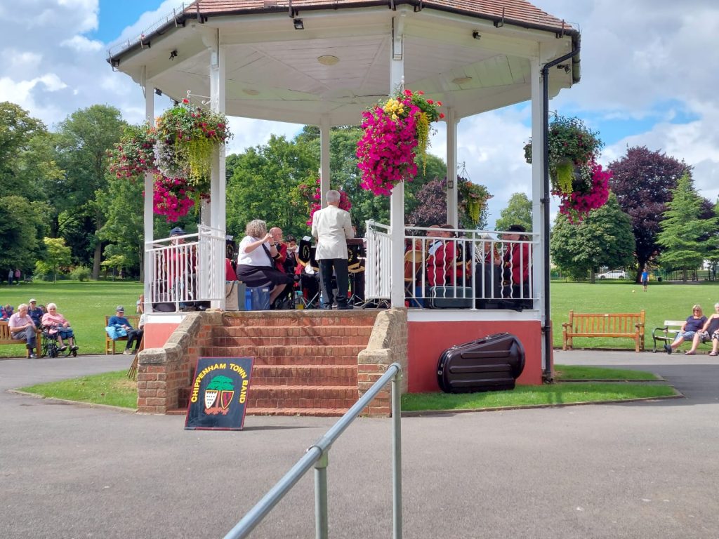 Chippenham Town Band playing at the bandstand in John Coles Park, Chippenham